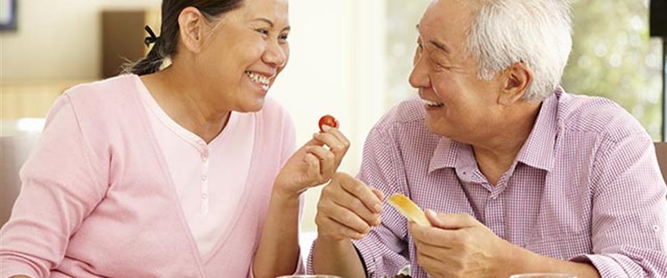 senior-asian-couple-sharing-meal-at-home